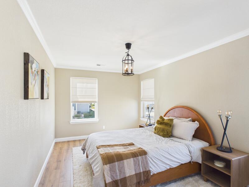 Bedroom with an arched wooden headboard and natural light