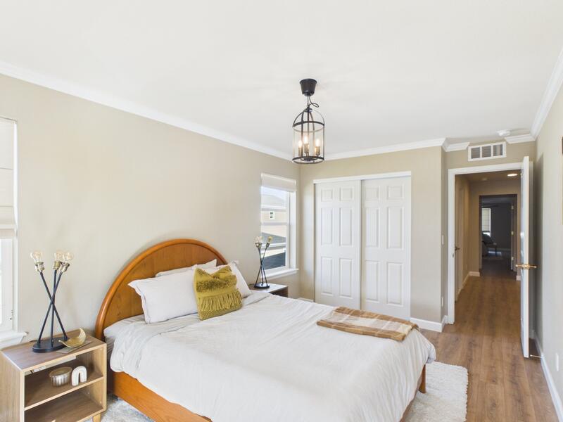Bedroom with a double-door closet and hallway view