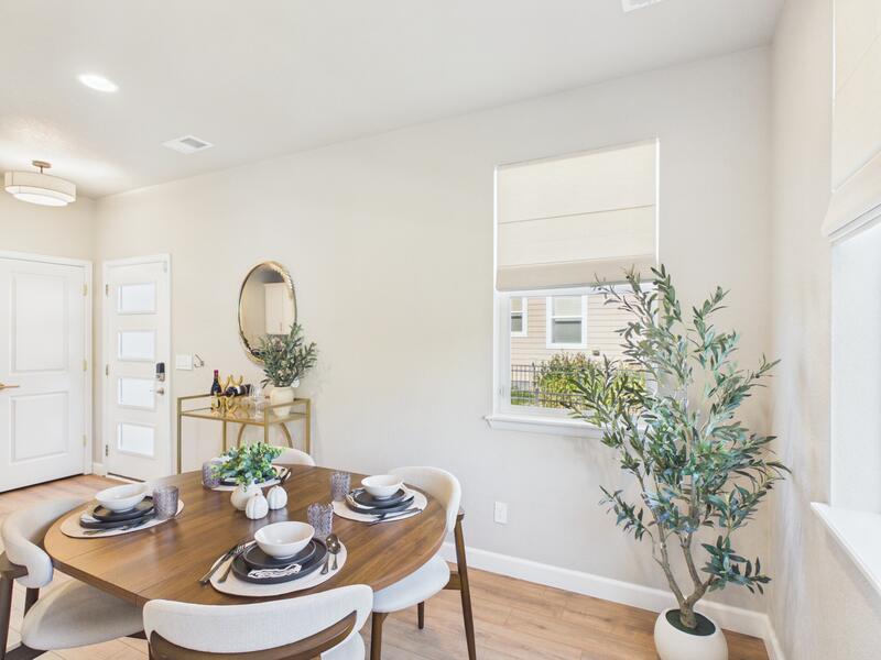 Dining area with a round table beside the living room at 619 Stonebridge Drive