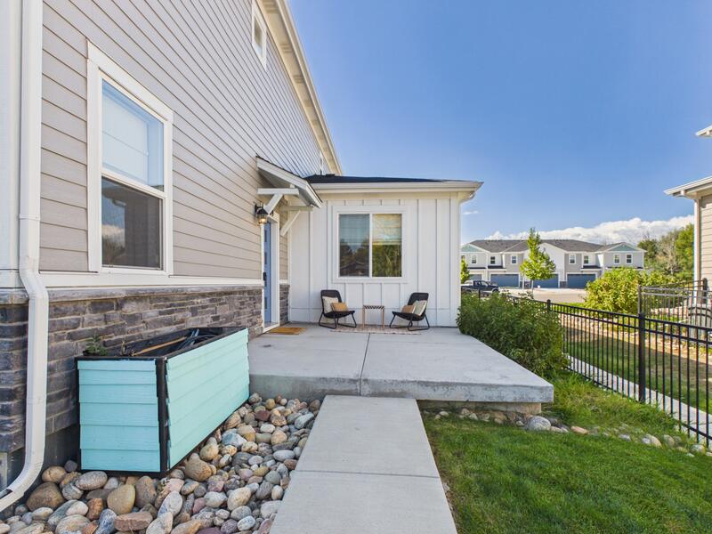 Fenced front patio with outdoor seating at 619 Stonebridge Drive