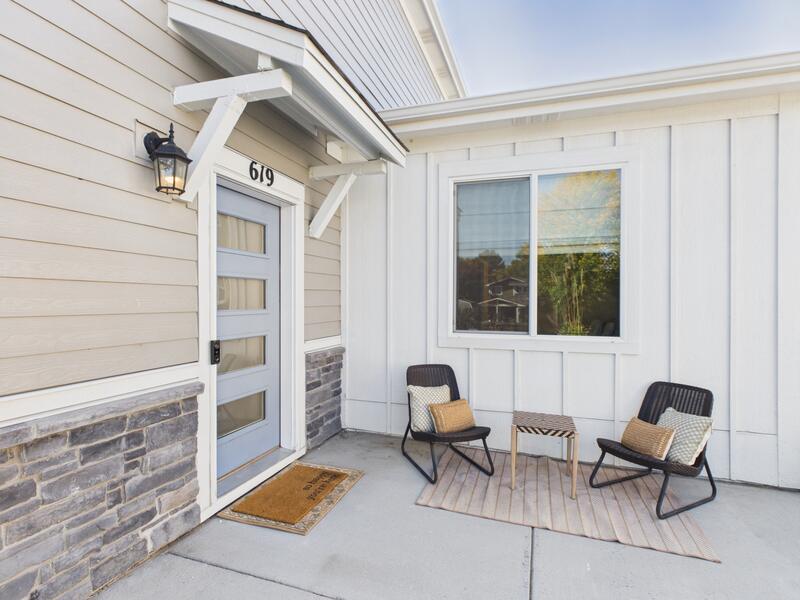 Front entry and patio of 619 Stonebridge Drive with a modern glass-panel front door