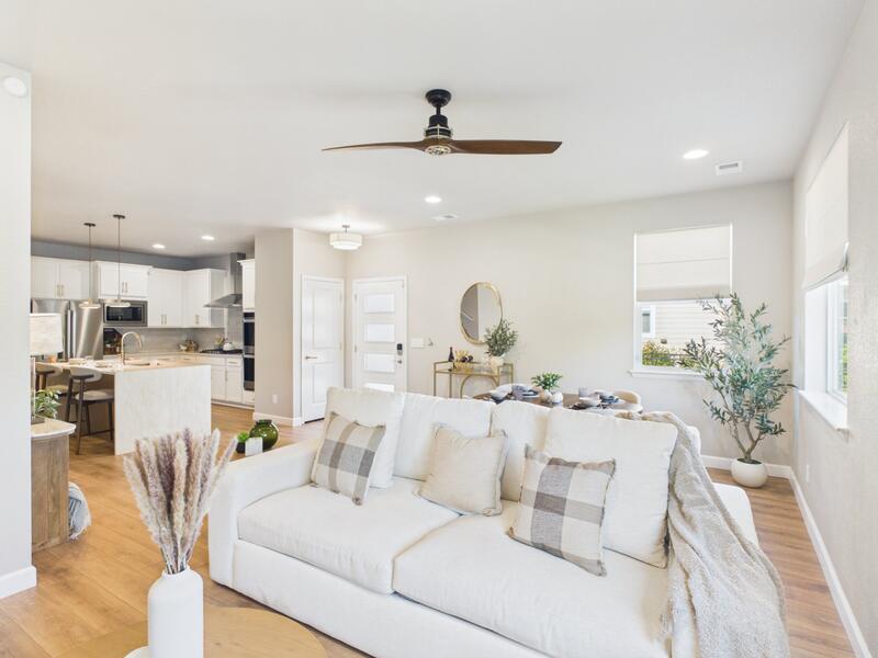 Great room with a ceiling fan opening to the kitchen and island