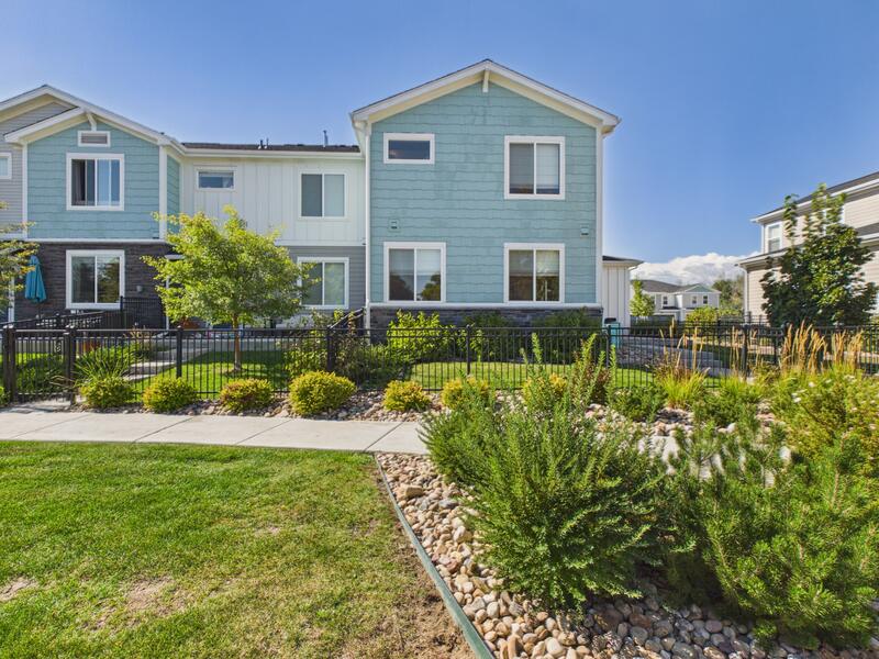 Landscaped lawn and walkway beside the townhome building at 619 Stonebridge Drive in Longmont