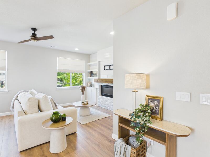 Living room with a gas fireplace and ceiling fan