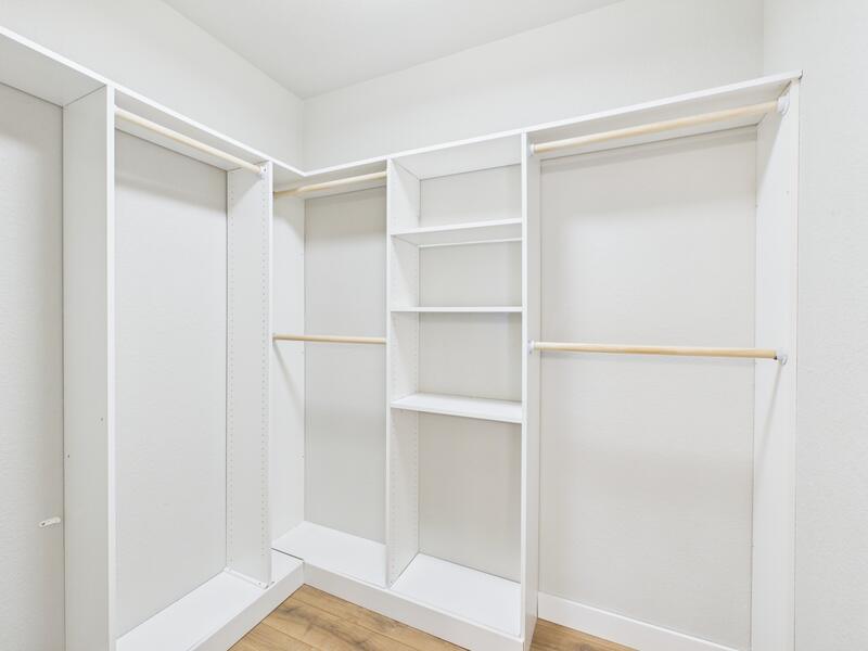 Walk-in closet with built-in shelving in the main-level suite