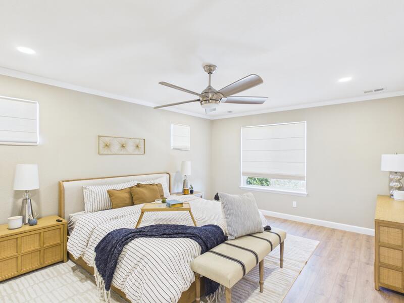 Primary bedroom with natural light, a ceiling fan, and recessed lighting